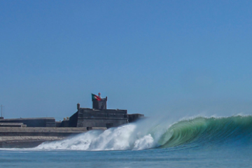 a person riding a wave on a surfboard in the water